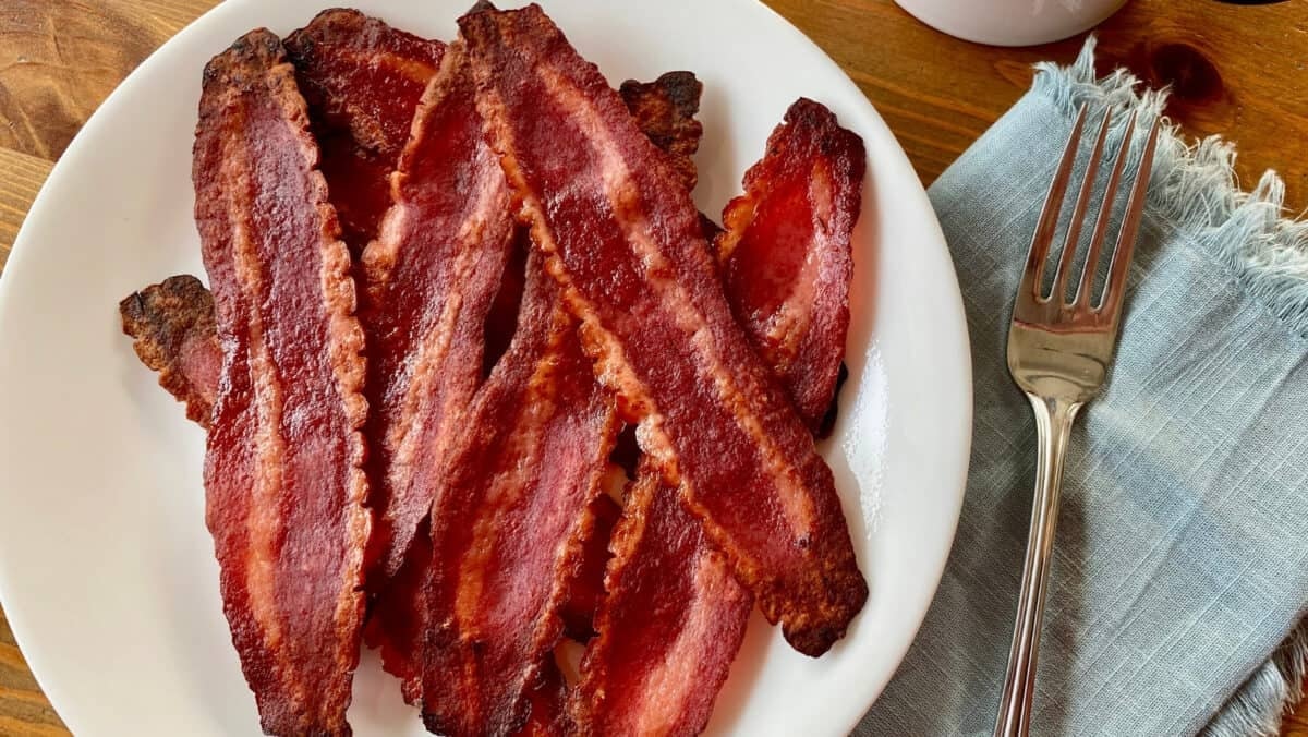 Turkey bacon from microwave on white plate ready to eat.