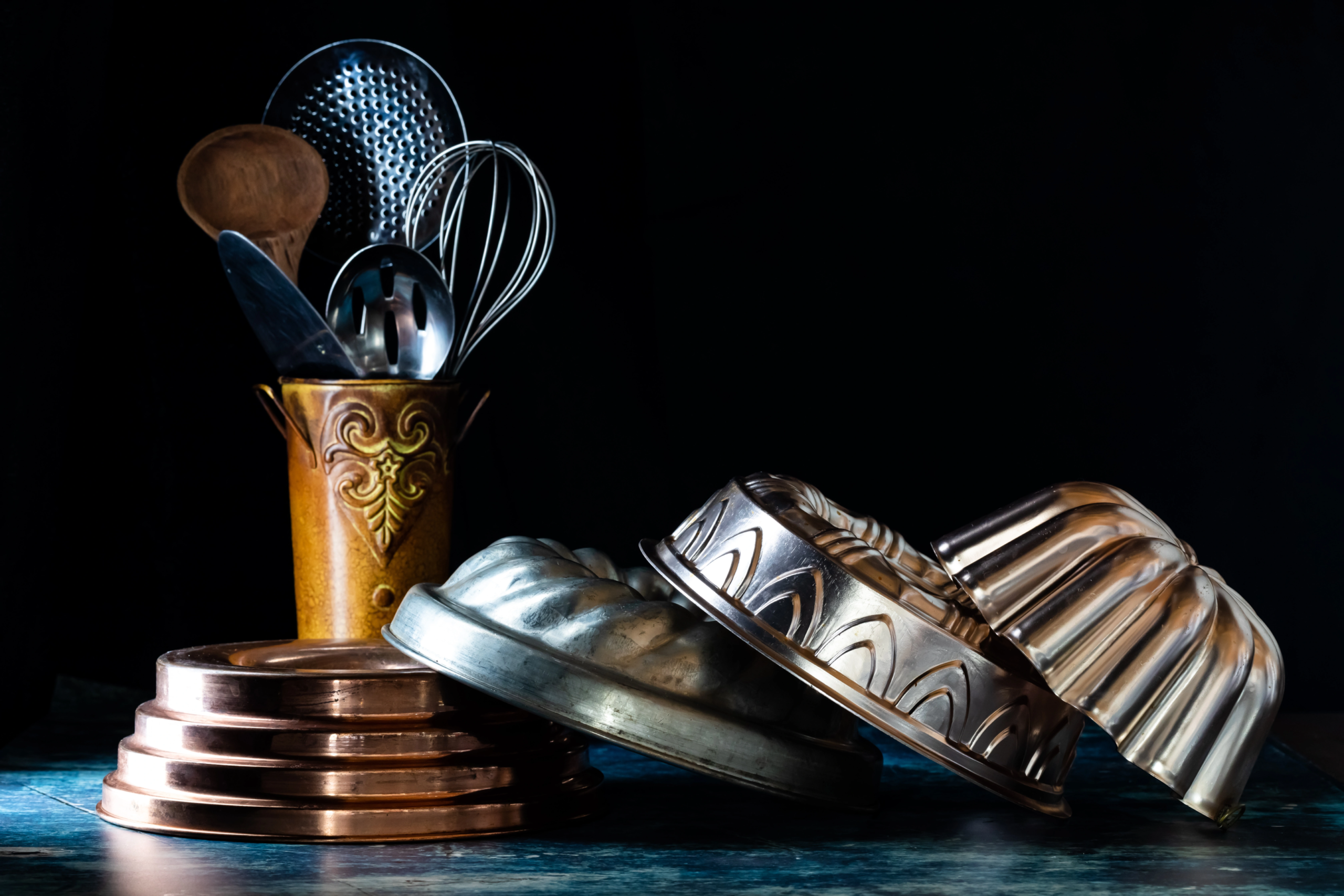 four types of cake pans with wooden canister holding utensils