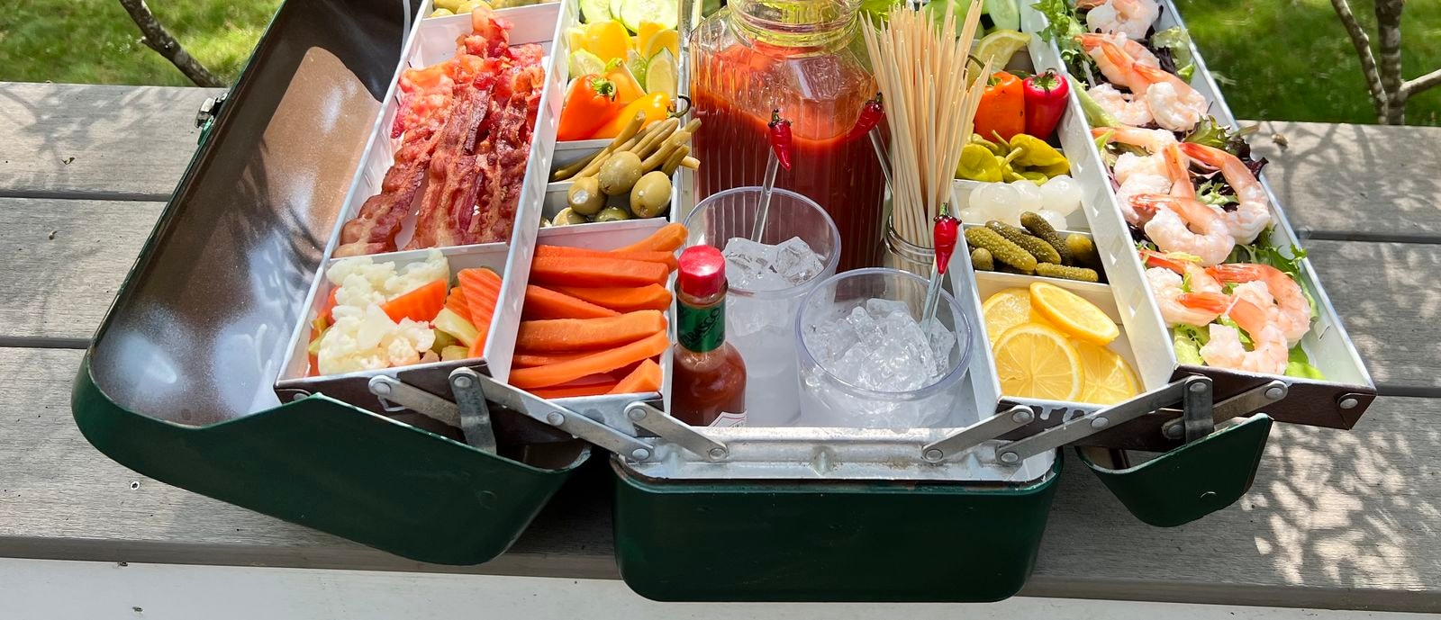 Snackle box with various items like veggies, shrimp and bacon.